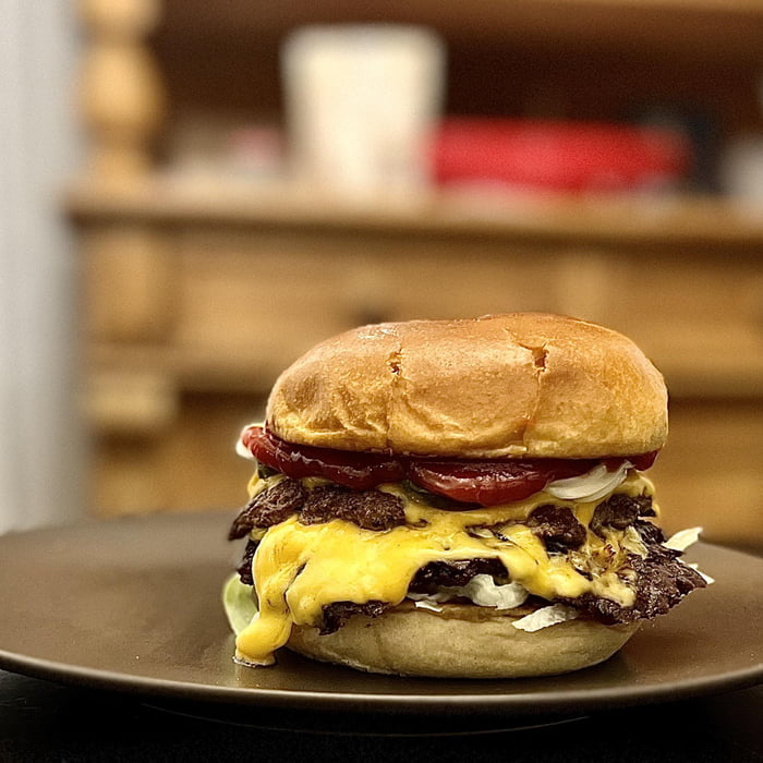 Double smash with 1x cheddar, 2x american cheese, pickles, lettuce, red