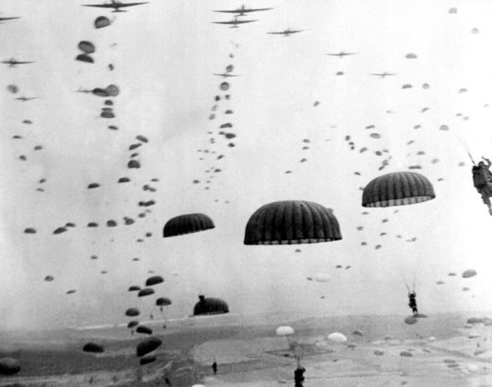 Parachutes Open As Waves Of Paratroops Land In Holland During