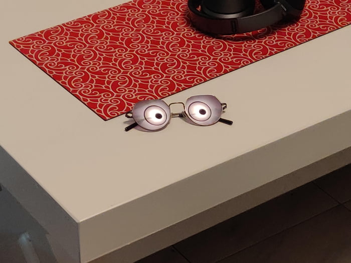 The reflection of the lamp on the sunglasses