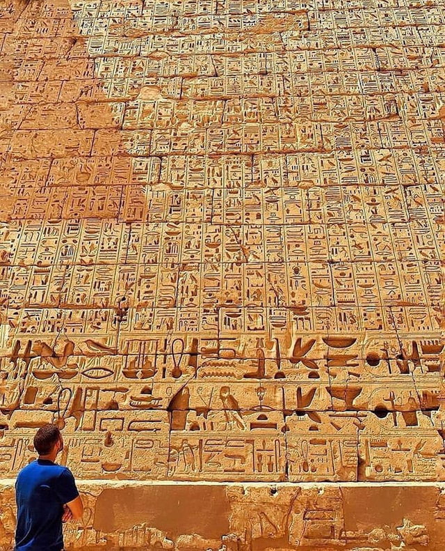 Hieroglyphics on the wall of The Temple of Ramesses III in Luxor, Egypt from around 1186-1156 BC.