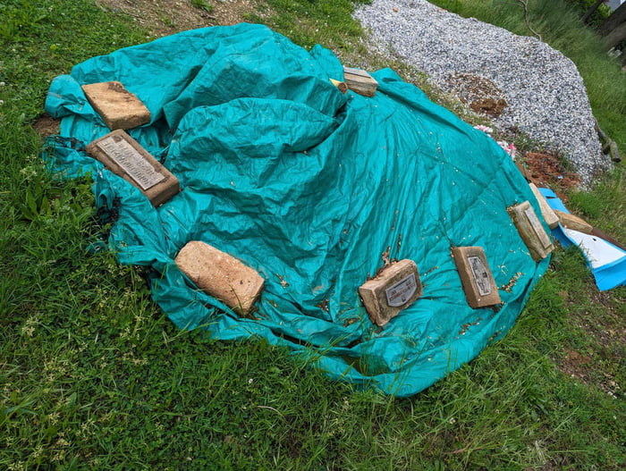 This cemetery using headstones to cover a tarp Cemetery was purchased This cemetery using headstones to cover a tarp Cemetery was purchased