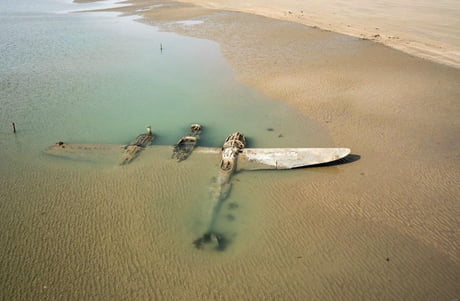 Sixty-five years after it crash-landed on a beach in Wales, an American P-38 fighter plane has emerged from the surf and sand where it lay buried 1