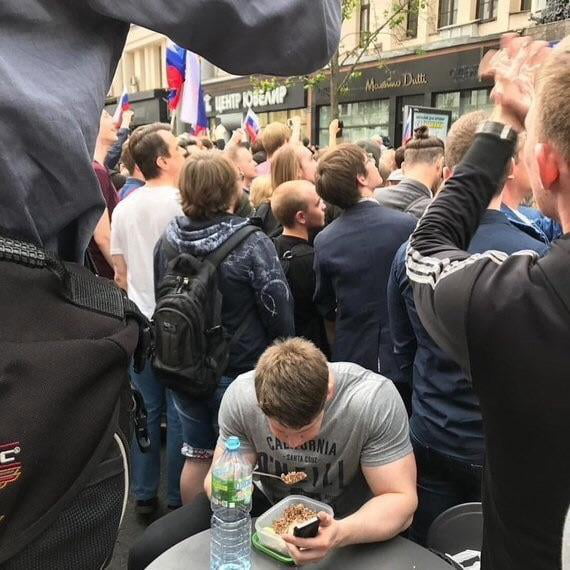 Trying to eat his breakfast in the middle of a protest