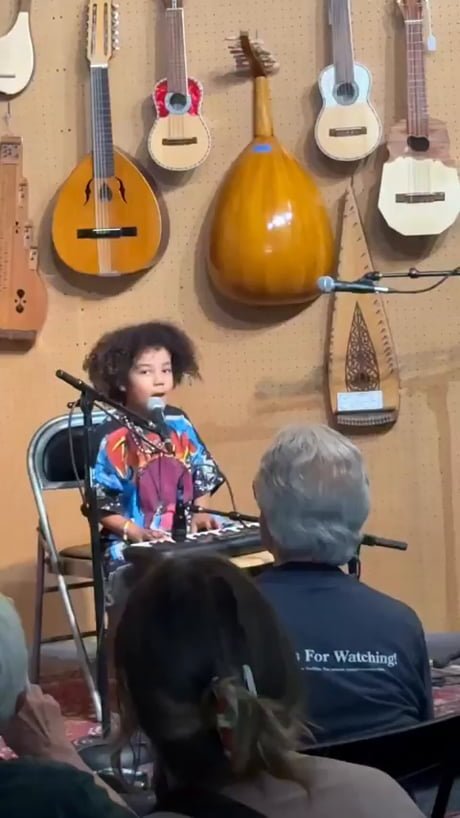 The confident kid rocking a colorful shirt and performing on stage